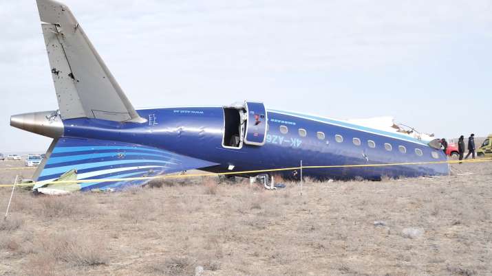 India Tv - The wreckage of Azerbaijan Airlines Embraer 190 lays on the ground near the airport of Aktau, Kazakh