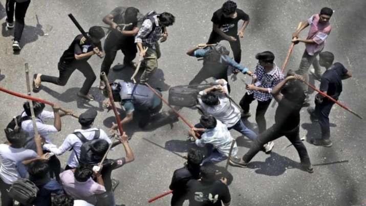 India Tv - A police officer was beaten during the violence in Bangladesh.