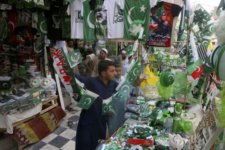 A vendor displays national flags, badges, masks and