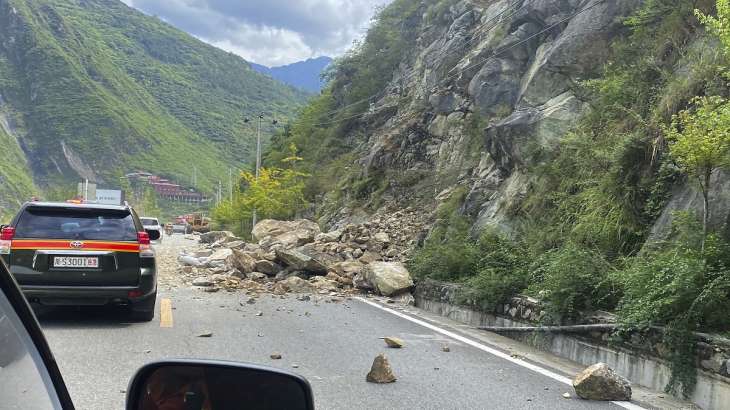In this photo released by Xinhua News Agency, fallen rocks