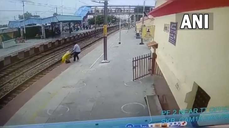 A viral video shows a woman crossing the railway tracks at