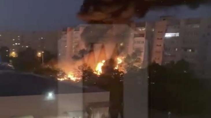 Flames and smoke engulf a building after a fighter jet crashes