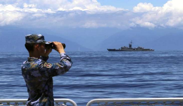 A People's Liberation Army member looks through binoculars