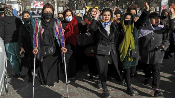 Afghan women chant slogans during a protest against the ban