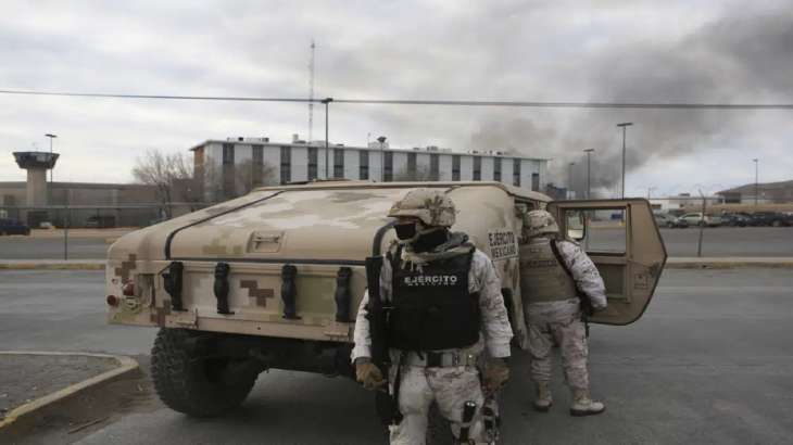 Mexican soldiers stand guard outside a state prison in