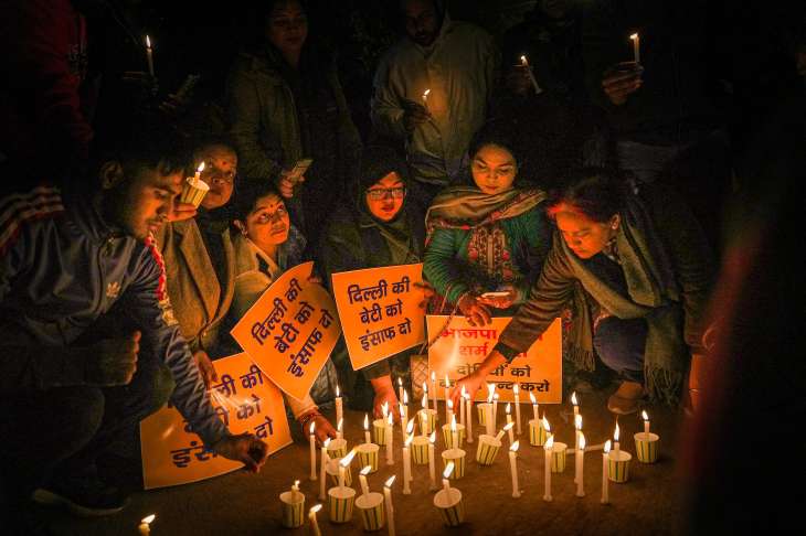 Candles lit during a march demanding justice for Anjali