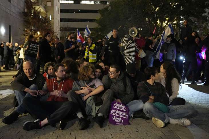 Activists lock arms in Tel Aviv, Israel, to protest against