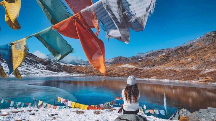 Representative image of a woman sitting in front of a lake