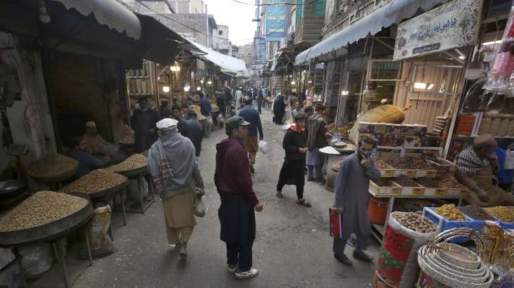 People visit a dry fruit market in the old area of