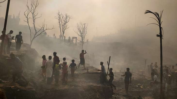 Rohingya refugees try to save their belongings one by one
