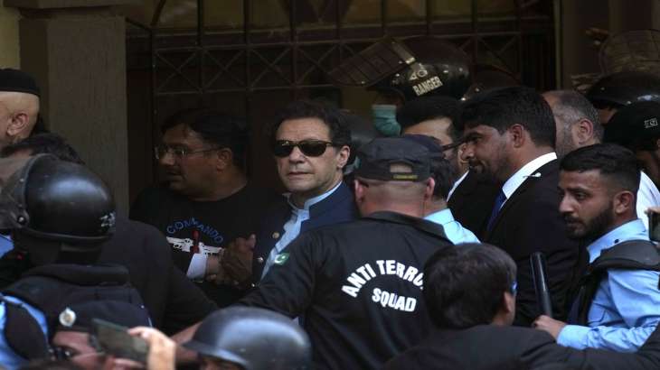 Pakistan's former Prime Minister Imran Khan is escorted by