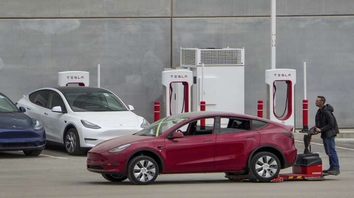 An employee drives a Tesla car at Tesla's Giga Texas Automotive