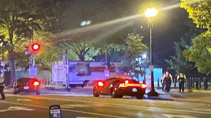 A box truck is seen crashed into a security barrier at a