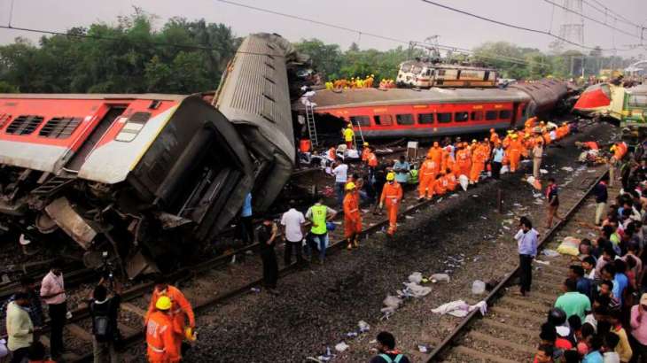 Rescuers work at the site of a passenger trains accident,