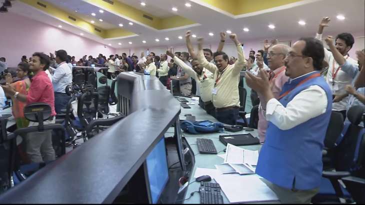 Scientists celebrate at the control room of ISRO