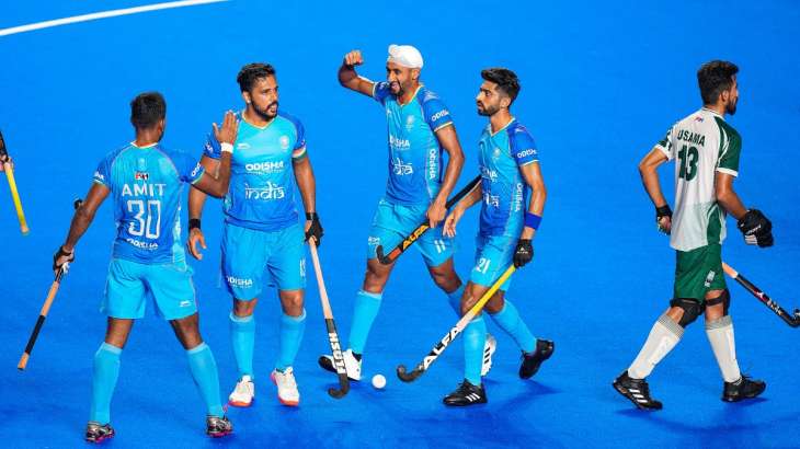 Indian players celebrate after scoring a goal against Pakistan