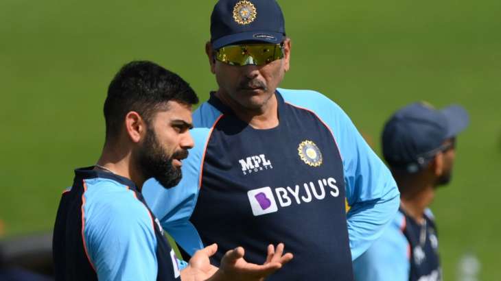 Virat Kohli speaks to Ravi Shastri during a training session