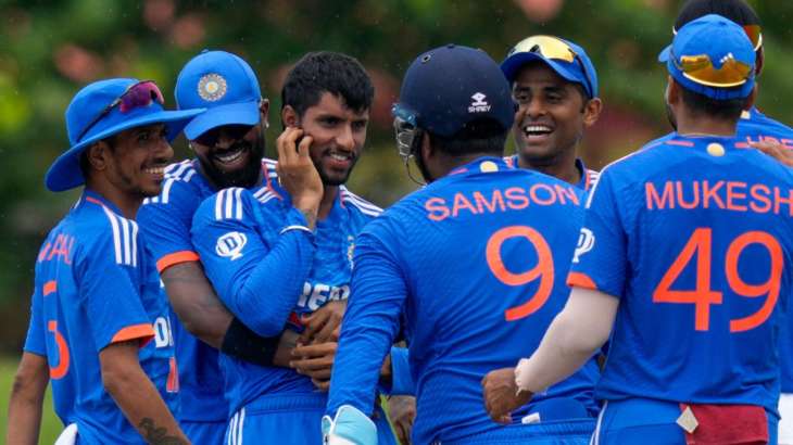 Indian players celebrating in a huddle