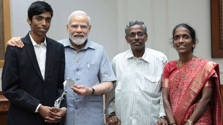 R Praggnanadhaa and his parents with Narendra Modi