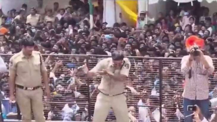 Police personnel dance during the 'Ganesh Visarjan'