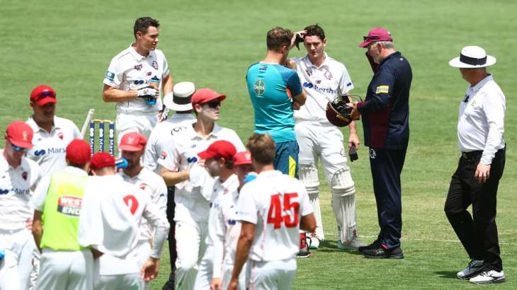 Jack Clayton of Queensland is hit on the helmet during a Sheffield Shield match