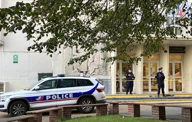 Police stand guard outside Gambetta-Carnot school, where a