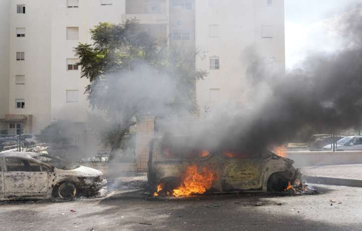 Cars set ablaze after Hamas launched a barrage of rockets