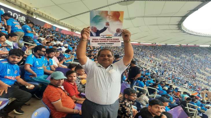 A cricket fan displays poster at Narendra Modi Stadium