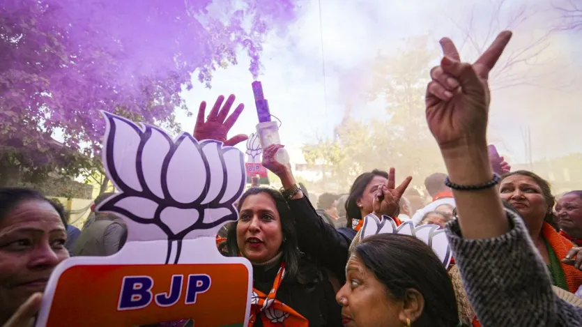 Bharatiya Janata Party supporters in Amritsar celebrate after the party secured a majority in the Delhi Assembly elections.