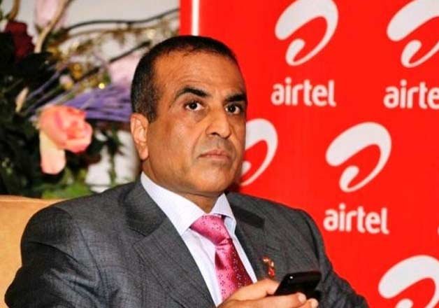 a man in a suit holding a phone | Sunil Bharti Mittal | Top 10 Richest People in Delhi | What do Delhi's Richest People do? 