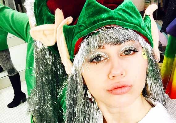 miley cyrus gears up for christmas with full elf costume after surgery see pics