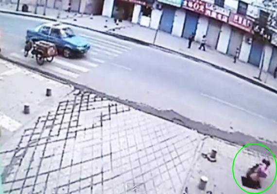 Girl on phone accidentally falls through hole in pavement