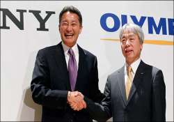 sony halves its stake with olympus