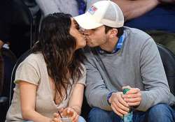 ashton kutcher mila kunis gets cosy during basketball match