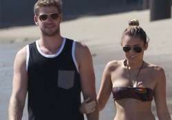 miley cyrus goes topless at beach