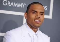 chris brown home raided by three masked men