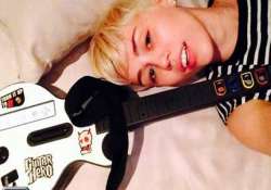 miley cyrus loves computer game guitar hero