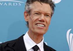 singer randy travis awake after suffering stroke