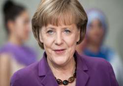 angela merkel pledges support for ukraine s development