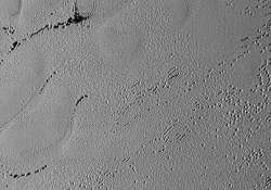 new image shows pluto s puzzling patterns pits