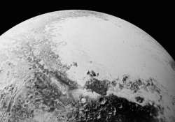 nasa releases new pluto pictures it has earth like mountains dunes