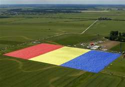 romanian village unfurls world s largest flag join guinness world records