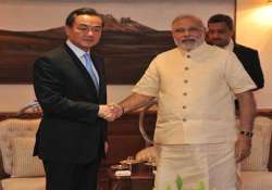 chinese foreign minister wang yi calls on narendra modi