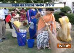 smriti irani makes surprise visit to govt school sweeps ground as part of swachh bharat abhiyan