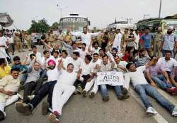 aiims issue congress workers stage protest burn dy cm s effigy