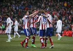 atletico thrashes real madrid 4 0 in derby to open up title race