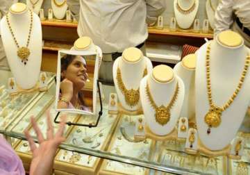 gold slips from record on sluggish demand at higher levels