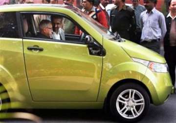pranab sits in driving seat of mahindra electric car reva at pmo