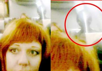 ghost or alien russian woman finds strange creature in selfie on passenger jet