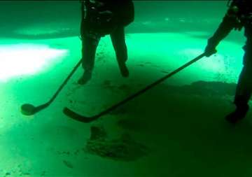 watch these siberian divers playing the first ever ice hockey match underwater